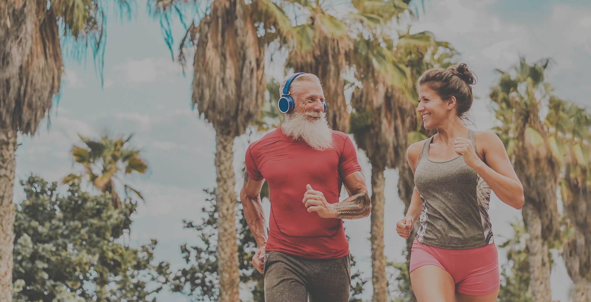 A fit, older couple outside jogging in Florida.
